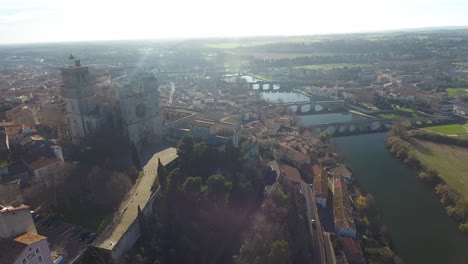 Amazing-aerial-drone-view-of-Beziers-cathedral-with-river-Orb-and-train-crossing